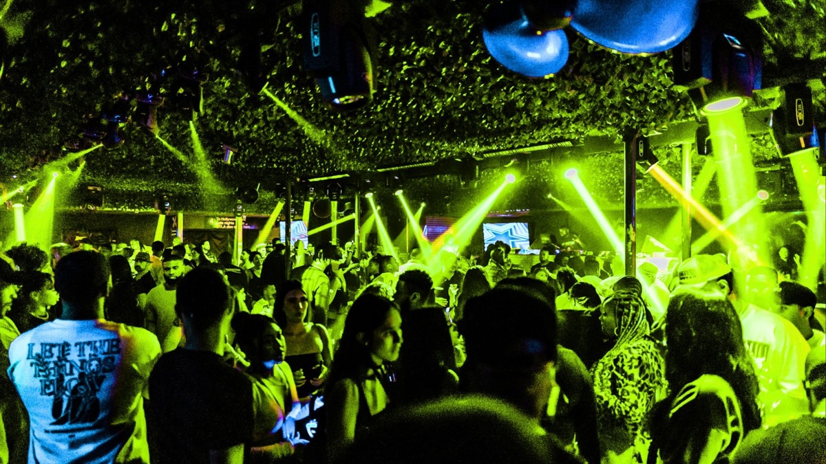 Packed dancefloor under green lasers at Jungle Hollywood