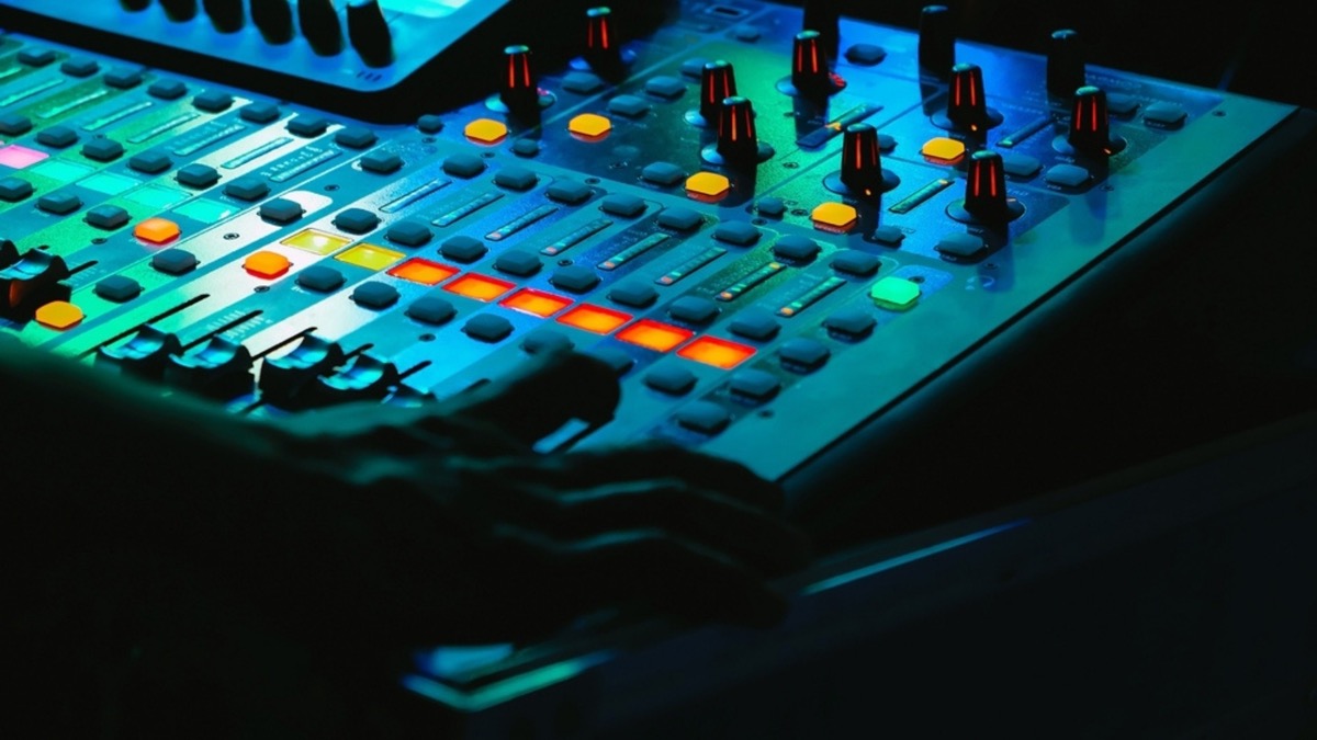 Mixing console glowing in the DJ booth